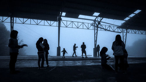 Silhouette people standing in corridor