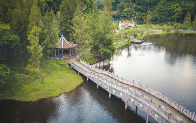 Stone bridge to the pavilion over the river calm water in natural park