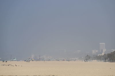 Panoramic view of beach against clear sky