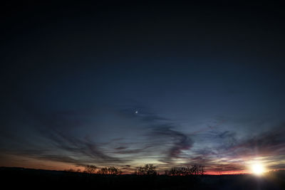 Silhouette landscape against sky at night