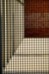 Full frame shot of metal grate on tiled floor