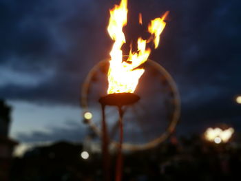 Close-up of illuminated fire against sky at night
