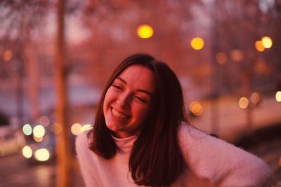 Portrait of a smiling young woman in city