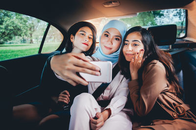 Portrait of woman sitting in car