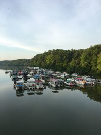 Boats moored on lake against sky