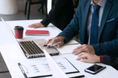 Midsection of business people working on table