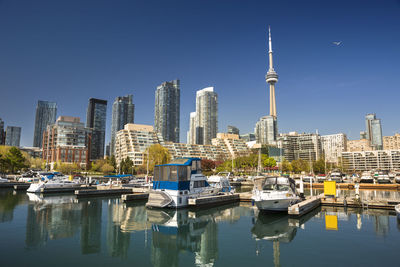 Boats moored in canal with buildings in background