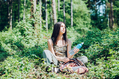 Young woman sitting in the forest
