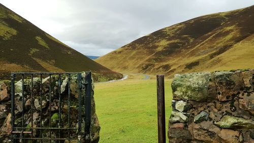 Scenic view of landscape against cloudy sky