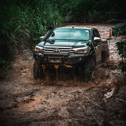 Abandoned car on dirt road