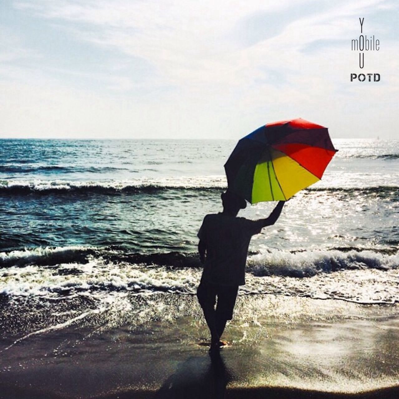 sea, horizon over water, rear view, leisure activity, lifestyles, full length, sky, men, beach, holding, water, standing, shore, person, umbrella, flag, cloud - sky, outdoors