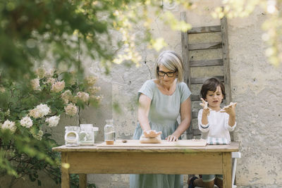 Mother and daughter on table