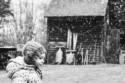 Side view of girl outdoors during snowfall