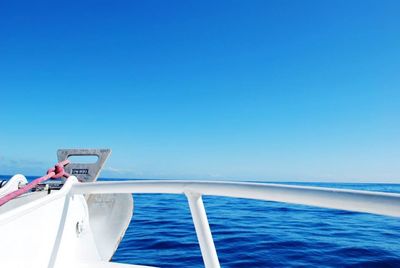 Boat in calm sea against clear sky