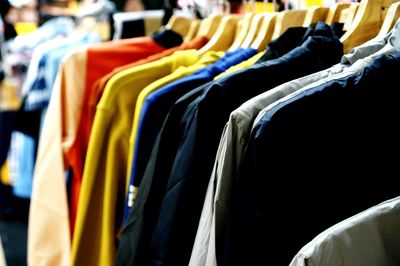 Close-up of clothes hanging on rack in store