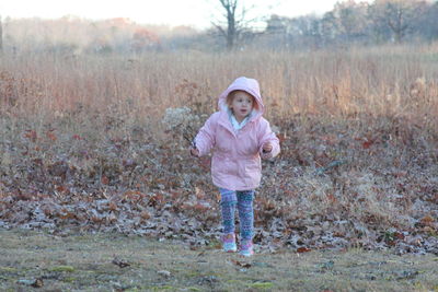 Portrait of girl standing on field