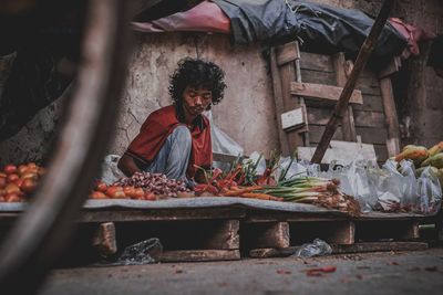 Mid adult man selling vegetables at market