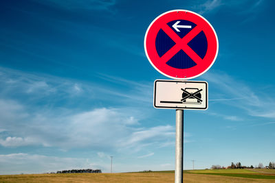 Road sign against sky