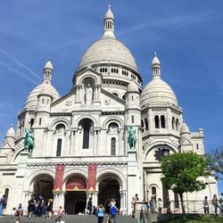 People at cathedral against sky