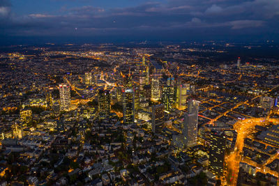 High angle view of illuminated cityscape against sky at night