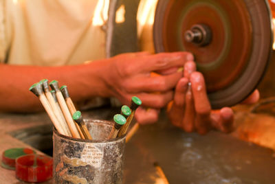 Close-up of man working at workshop