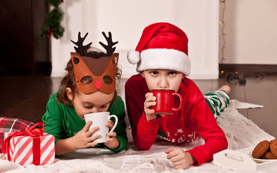 Cute kids drinking hot chocolate at home