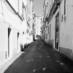 Road amidst city against sky
