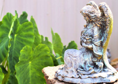 Close-up of statue against water