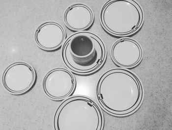 High angle view of tea in cup amidst saucers on table