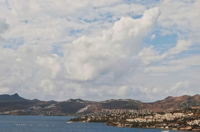 Panoramic view of sea and mountains against sky