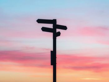 Low angle view of silhouette cross against sky during sunset