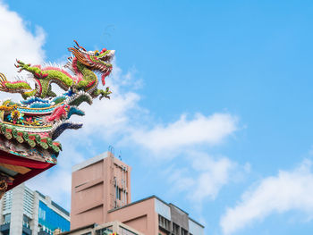 Low angle view of multi colored building against sky