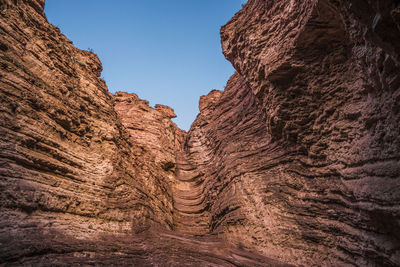 Rock formation on land against clear sky