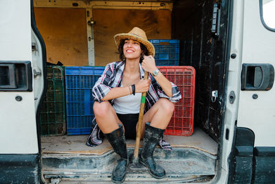 Full length of woman sitting in van