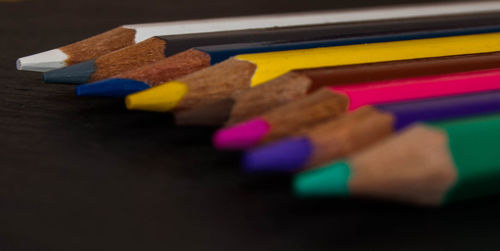 Close-up of multi colored pencils on table