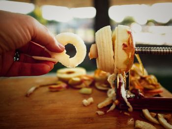 Close-up of hand holding food on table