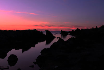 Scenic view of lake against romantic sky at sunset