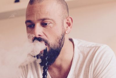 Close-up of man smoking hookah