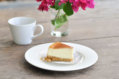 Coffee cup and cake on table