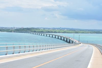 Road by sea against sky