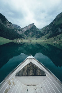 Cropped boat in lake against mountain range