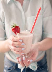 Midsection of man holding drink