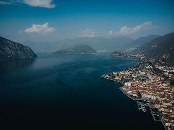 High angle view of sea and mountains against sky