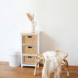 Table and chairs against white wall