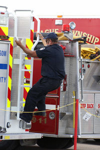 Rear view of man with arms raised