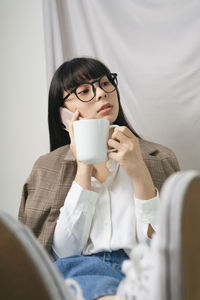 Portrait of woman with coffee cup