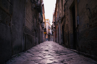 Narrow alley amidst buildings in city