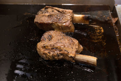 High angle view of meat on barbecue grill