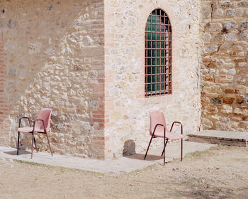 Empty chairs and tables in yard