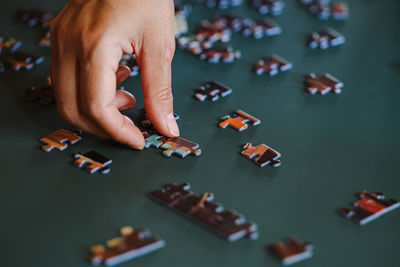 High angle view of woman playing with puzzle